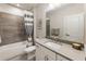 Stylish bathroom with tile accents, a bathtub with shower, and a modern vanity at 2068 Cortland Rd, Milton, GA 30009