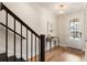 Bright entryway featuring hardwood floors, modern lighting, and a staircase with black railings at 2068 Cortland Rd, Milton, GA 30009