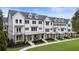 Beautiful townhome exteriors feature white siding, black trim, and inviting front porches at 2068 Cortland Rd, Milton, GA 30009
