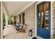 Inviting front porch with brick flooring, rocking chairs, and an exterior lantern at 2068 Cortland Rd, Milton, GA 30009
