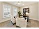 Comfortable home office with natural light, white armchairs, and a modern work desk at 2068 Cortland Rd, Milton, GA 30009