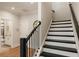 Staircase view leading to a bathroom featuring gray accents and black railings at 2068 Cortland Rd, Milton, GA 30009