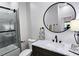 Contemporary bathroom with a soaking tub and shower combination behind a glass enclosure at 2152 Castlewood St, East Point, GA 30344