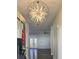 Grand entryway with an ornate chandelier, dark hardwood floors, and high ceilings at 2152 Castlewood St, East Point, GA 30344