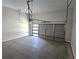 View of an empty garage with concrete floors, a garage door and visible garage door opener at 2152 Castlewood St, East Point, GA 30344