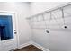 Laundry room with wire shelving, utility connections, and a door with glass inserts at 2152 Castlewood St, East Point, GA 30344