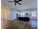 Open concept living room, dining room, and kitchen with an island and white cabinets at 2152 Castlewood St, East Point, GA 30344