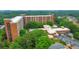 Elevated view showcasing the brick apartment complex, its refreshing pool, and lush green trees at 300 Johnson Ferry Ne Rd # A1008, Atlanta, GA 30328