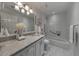 Elegant bathroom featuring a marble countertop, vanity, and a tiled shower with a glass door at 300 Johnson Ferry Ne Rd # A1008, Atlanta, GA 30328