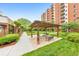 A serene courtyard with a gazebo, lush greenery, and a brick apartment building for a peaceful outdoor setting at 300 Johnson Ferry Ne Rd # A1008, Atlanta, GA 30328