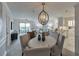 Bright open concept dining area with stylish chandelier, and view of kitchen and living room at 300 Johnson Ferry Ne Rd # A1008, Atlanta, GA 30328