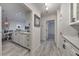 Hallway view with marble counters, white cabinets, gray flooring and an open doorway at 300 Johnson Ferry Ne Rd # A1008, Atlanta, GA 30328