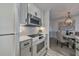 Bright eat-in kitchen with white appliances, marble countertops, and stylish backsplash at 300 Johnson Ferry Ne Rd # A1008, Atlanta, GA 30328