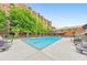 A refreshing outdoor pool surrounded by lounge chairs, trees, and an apartment building for summer fun at 300 Johnson Ferry Ne Rd # A1008, Atlanta, GA 30328