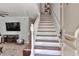 Bright entryway features classic staircase and a coat rack perfect for coming in from outdoors at 8 Arpege Nw Way, Atlanta, GA 30327