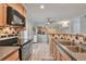 Open kitchen layout with modern appliances, tile backsplash, and plenty of natural light at 8 Arpege Nw Way, Atlanta, GA 30327