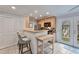 Bright kitchen boasts modern appliances, breakfast bar, and access to outdoor patio at 8 Arpege Nw Way, Atlanta, GA 30327