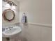 Charming powder room with pedestal sink, decorative mirror, and elegant lighting at 8 Arpege Nw Way, Atlanta, GA 30327