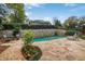 Backyard pool with stone patio enhanced by elegant landscaping and a retaining wall at 219 Little John Ne Trl, Atlanta, GA 30309