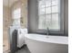 Bright bathroom with a modern soaking tub, glass enclosed shower, and natural light at 219 Little John Ne Trl, Atlanta, GA 30309