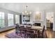 Elegant dining room with hardwood floors, natural light, and a decorative fireplace offering a warm ambiance at 219 Little John Ne Trl, Atlanta, GA 30309