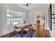 Charming dining area with hardwood floors and natural light streaming through a large window at 219 Little John Ne Trl, Atlanta, GA 30309