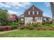 Charming exterior view of a two-story home with a manicured lawn and stone staircase with colorful foliage at 219 Little John Ne Trl, Atlanta, GA 30309