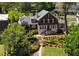 Beautiful two-story home with manicured lawn, stone steps, and mature trees offering a charming curb appeal at 219 Little John Ne Trl, Atlanta, GA 30309