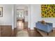 Bright foyer with hardwood floors, white trim, and a stylish sitting area featuring unique sunflower artwork at 219 Little John Ne Trl, Atlanta, GA 30309