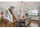 Bright kitchen with an island, granite countertops, stainless steel appliances, and stylish pendant lighting fixtures at 219 Little John Ne Trl, Atlanta, GA 30309
