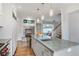Spacious kitchen featuring stainless steel appliances, an island, hardwood floors, and a view to an adjoining living area at 219 Little John Ne Trl, Atlanta, GA 30309