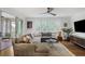 Bright living room with large sectional sofa, hardwood floors, and screened-in porch at 219 Little John Ne Trl, Atlanta, GA 30309