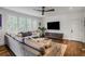 Living room with hardwood floors, large sectional sofa, and TV on wall at 219 Little John Ne Trl, Atlanta, GA 30309