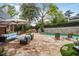 Backyard pool area with stone patio and outdoor seating at 219 Little John Ne Trl, Atlanta, GA 30309