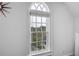 An arched window offers a view of the surrounding trees and neighborhood at 219 Little John Ne Trl, Atlanta, GA 30309