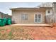 Backyard featuring a concrete patio, and green garbage bins at 6502 Wellington Chase Ct, Lithonia, GA 30058