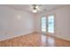 Bedroom with neutral walls, hardwood floors, and a glass door at 6502 Wellington Chase Ct, Lithonia, GA 30058