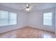 Bright bedroom with neutral walls, hardwood floors, and a ceiling fan at 6502 Wellington Chase Ct, Lithonia, GA 30058