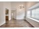Elegant dining area boasting hardwood floors, a modern chandelier, and abundant natural light at 6502 Wellington Chase Ct, Lithonia, GA 30058