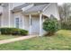 Inviting home exterior featuring a well-manicured lawn and a charming, covered front entrance at 6502 Wellington Chase Ct, Lithonia, GA 30058