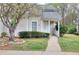 Charming home with manicured front yard, walkway, and blooming tree at 6502 Wellington Chase Ct, Lithonia, GA 30058