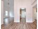 Open living area featuring hardwood floors with a view to the kitchen and staircase at 6502 Wellington Chase Ct, Lithonia, GA 30058
