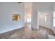Spacious living area with light wood floors, a peek-through to the kitchen, and a bright entryway at 6502 Wellington Chase Ct, Lithonia, GA 30058