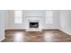 Cozy living area with a marble fireplace, wood-style floors, and bright, inviting windows at 6502 Wellington Chase Ct, Lithonia, GA 30058