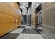 Modern hallway with wood paneled wall, elevator, and decorative floor at 3338 Peachtree Ne Rd # 2701, Atlanta, GA 30326