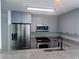 Modern kitchen featuring stainless steel appliances, gray cabinetry, granite counters, and stylish tile backsplash at 3338 Peachtree Ne Rd # 2701, Atlanta, GA 30326