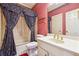 Traditional bathroom with bathtub, patterned wallpaper, and gold fixtures at 3395 Hunters Place, Stonecrest, GA 30038