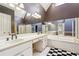 Well-lit bathroom featuring double sink vanity, jacuzzi tub, and glass shower at 3395 Hunters Place, Stonecrest, GA 30038
