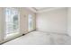 Neutral bedroom featuring two windows and carpeted flooring at 3395 Hunters Place, Stonecrest, GA 30038