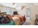 Bedroom with carpeted floors, a ceiling fan, and natural light at 3395 Hunters Place, Stonecrest, GA 30038